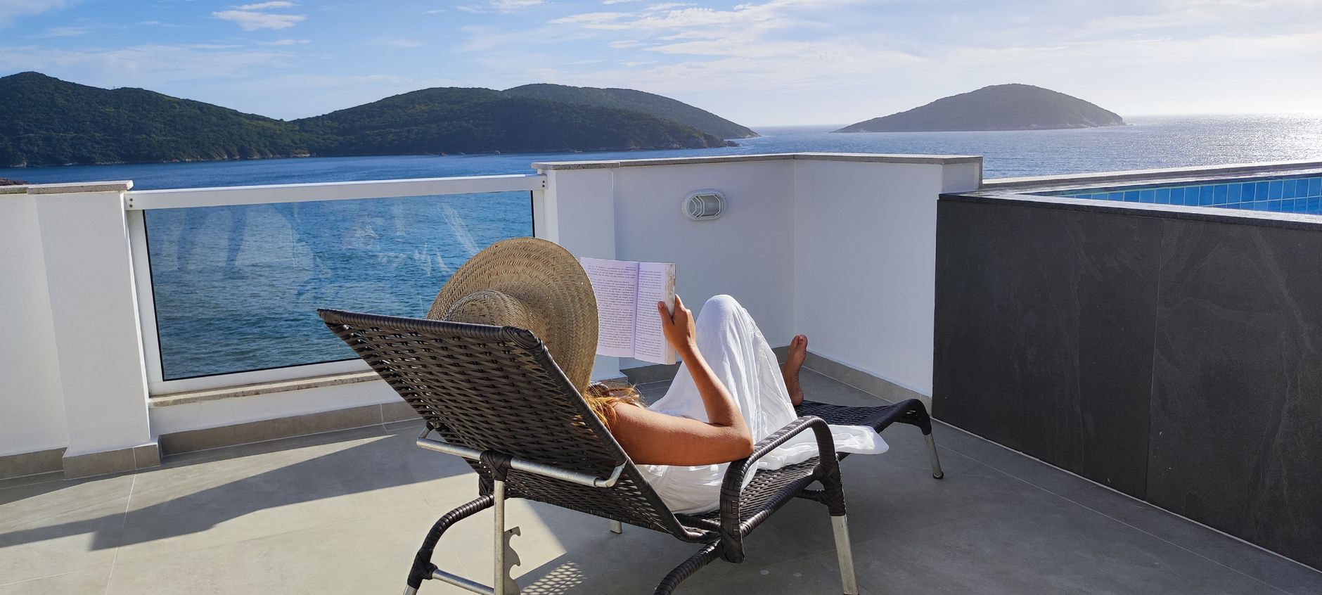 Travel writer reviewing notes beside open coastal view